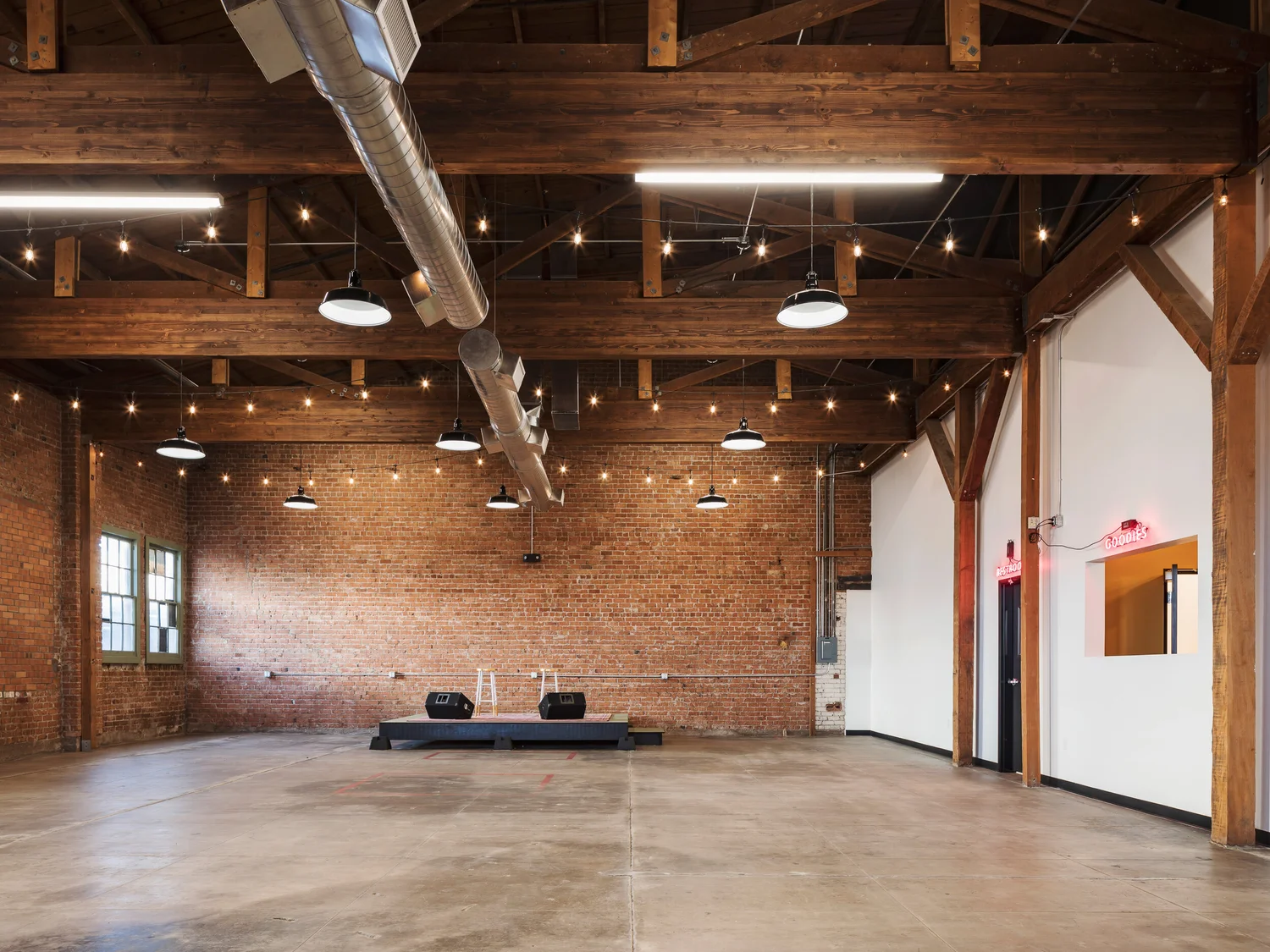 The Big Room with brick walls and timber ceiling